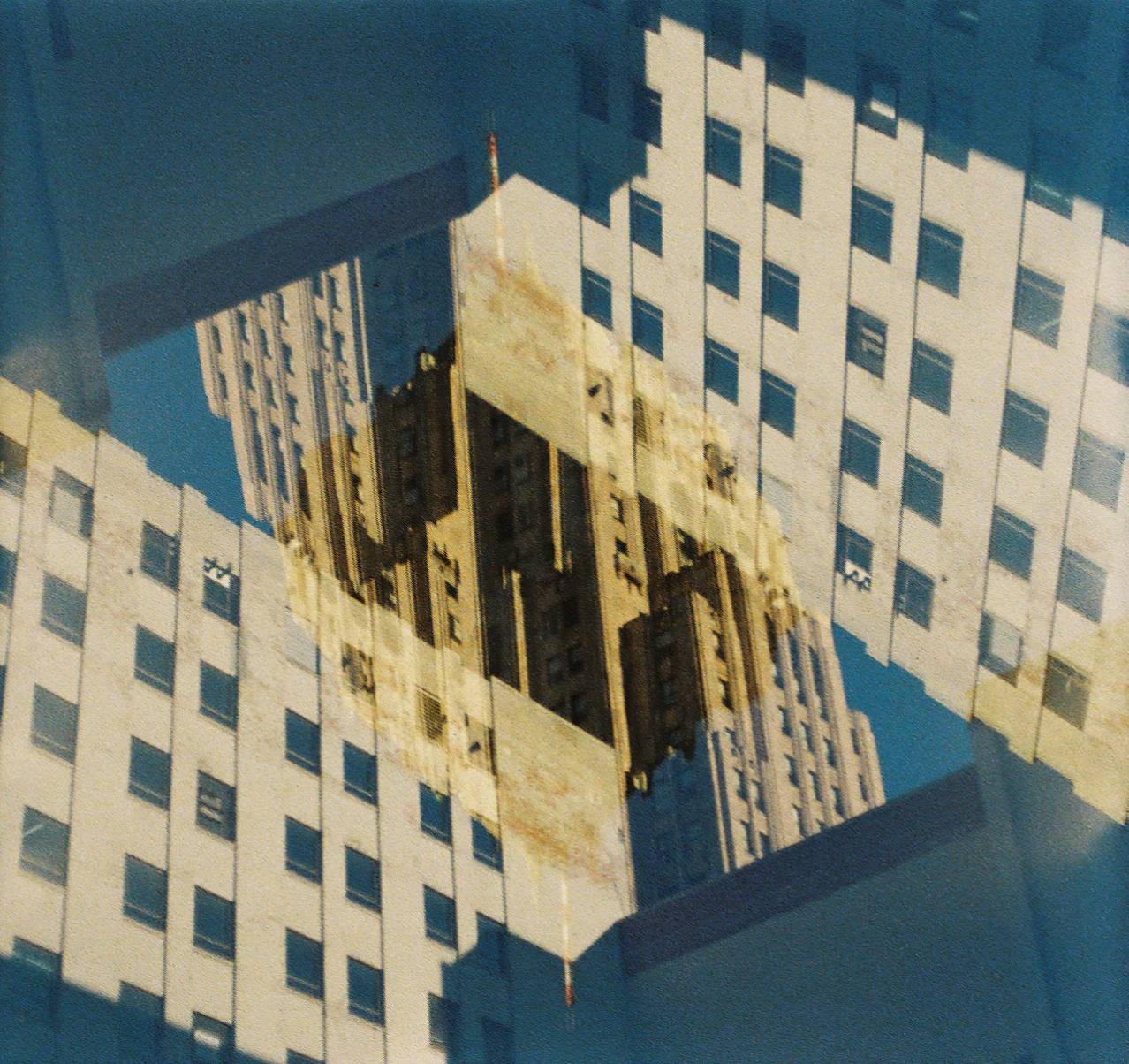 Two overlaid images of a skyscrpaer buildings against a buile sky